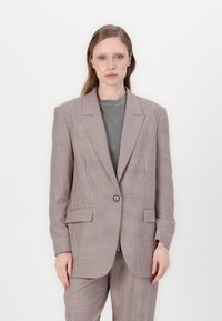 Dobbeltspent blazer i lysebrun houndstooth-mønster, med en enkelt knappelukking, klaffelapper og lommer med klaff.