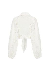 Blusa bianca corta con maniche lunghe, motivi floreali a ricamo e chiusura con cravatta sul retro. Tessuto morbido e leggero.