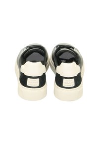 Sneakers with a black leather upper and white rubber sole; features a suede heel accent and a branded patch on the rear.