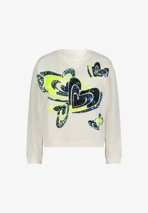 Kremowa bluza z nadrukiem serc z cekinów w kolorach zielonym, niebieskim i czarnym. Okrągły dekolt i długie rękawy zakończone ściągaczami.