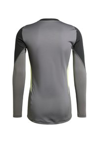 T-shirt de sport à manches longues en gris avec des accents noirs et jaunes. Tissu lisse et extensible avec des zones ventilées, dotée d'un col rond.