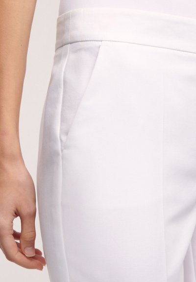 White trousers with a smooth texture, featuring a side pocket and a tailored waistband for a fitted appearance.