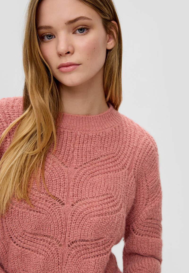 Rosa gestrickter Pullover mit einem strukturierten Wellenmuster, runder Ausschnitt und langen Ärmeln, aus einem weichen, dicken Garn gefertigt.