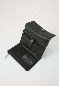 Black leather wallet with a fold-over flap, interior card slots, and clear ID pocket. Features a silver zipper and branding on the exterior.