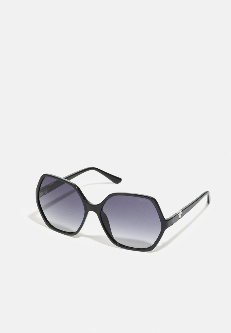 Black octagonal sunglasses with gradient gray lenses. Features include sleek frame design and minimal hardware accents on the arms.