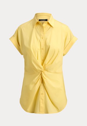 Κίτρινη μπλούζα με κοντά μανίκια και κουμπιά, με γιακά και μπροστινή λεπτομέρεια με κόμπο, κατασκευασμένη από λείο ύφασμα.