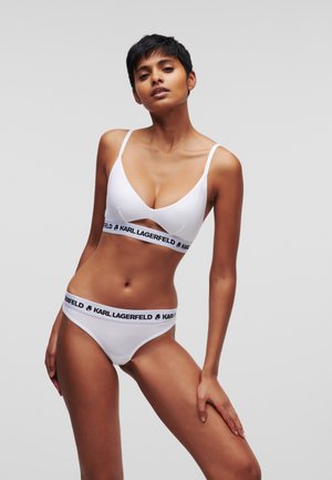White cotton bra and underwear with a black Karl Lagerfeld logo band. Bra features thin straps and a V-shaped neckline.