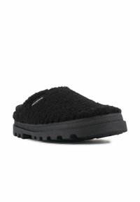 Crne slip-on cipele s teksturiranim, paperjastim gornjim dijelom i izdržljivom gumenom potplatnom sole s uzorkom za prianjanje. Logo je vidljiv sa strane.