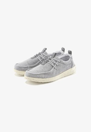 Gray fabric shoes with a soft texture, rounded toe, and elastic laces. Features a light, speckled outsole for added grip.