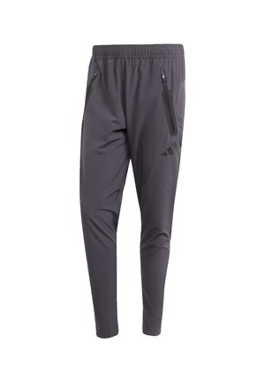 Grey athletic pants featuring an elastic waistband, zippered side pockets, tapered design, and subtle logo accents on the thigh.