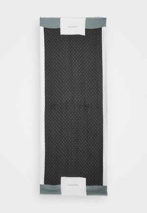 Écharpe Calvin Klein en noir et blanc avec un motif "CK" répété et des sections de bordure grises aux extrémités courtes.