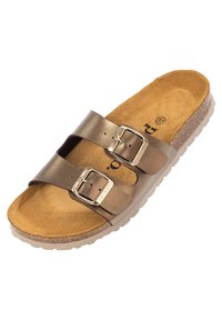 Sandale en cuir marron à glissière avec deux boucles réglables, semelle en liège et semelle en caoutchouc texturée. Design simple avec un profil plat.