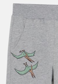 Gray sweatpants featuring a ribbed waistband and two cartoon pterodactyls in teal and brown on the left pocket area.