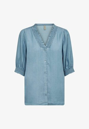 Hele sinine chambray pluus V-kaelusega, ripsitud varrukatega ja nööpidega esiosal. Omab volangdetaili kaeluseäärtes.