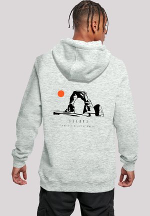Gray hoodie featuring a black graphic of an arch and a sun in orange. Text reads "ESCAPE" along with additional details below the graphic.