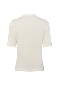 Lichtbeige polo shirt met korte mouwen en opgerolde manchetten, tot halverwege de taille, gemaakt van soepel materiaal. Voorzien van een klassieke kraag voor een strakke uitstraling.