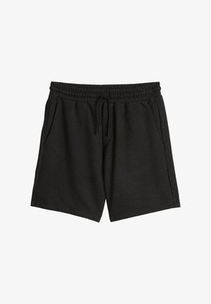 Short noir en tissu éponge avec taille élastique, cordon de serrage et poches latérales, présenté à plat sur fond blanc.