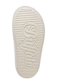 Semelle de chaussure en caoutchouc blanc avec rainures horizontales et logo texte stylisé en relief au centre.