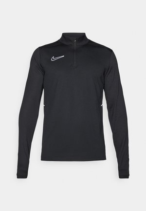 Maglietta sportiva nera a maniche lunghe con collo a zip quarti, logo Nike in bianco e dettagli laterali bianchi a contrasto. Tessuto dalla texture liscia.