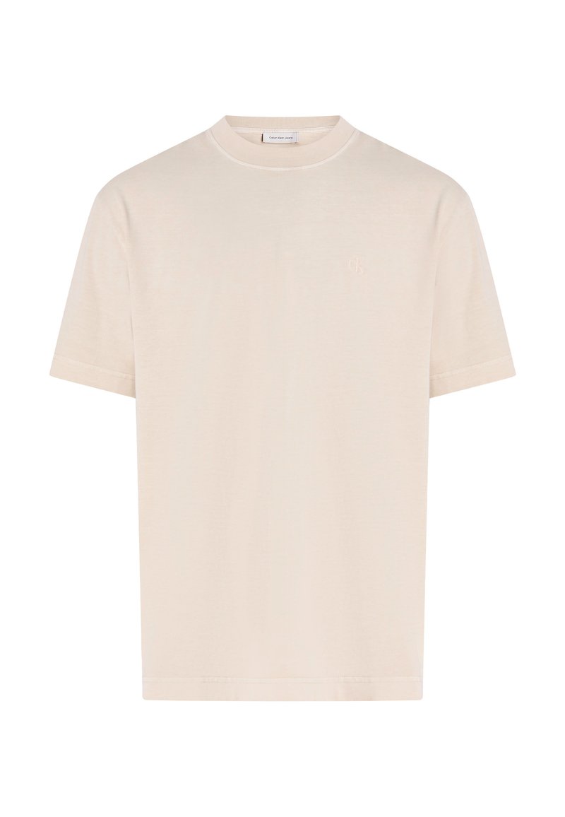 T-shirt à manches courtes de couleur crème en tissu doux. Présente un col rond et un logo brodé discret sur la poitrine. Lavable en machine.