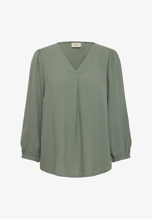 Roheline blouse V-kaelusega, pikkade puhv-ning varrukatega ning tekstureeritud kangast. Ees on pehmed voldid ja elastsed mansetid.