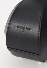 Fekete bőr kézi táska, amelyen dombornyomott "Patrizia Pepe" feliratozás található, sima felülettel, szögletes formával és masszív fém hardver kiegészítőkkel.