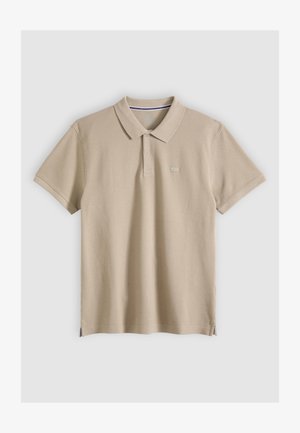 Beige short-sleeve polo shirt with a collar and two-button placket, small logo on left chest, laid flat on a light background.