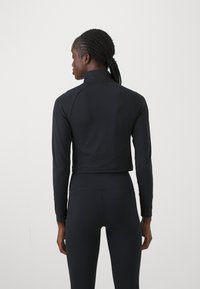 Under Armour VANISH SEAMLESS 1/4 ZIP CROP - Top dugih rukava - black/white