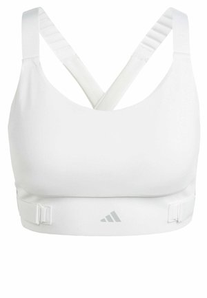White sports bra with a smooth texture, featuring crisscross straps, adjustable underbust clips, and a subtle logo on the front.