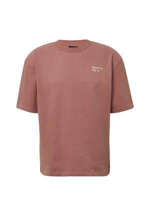 Rosa übergroßes T-Shirt aus Baumwolle mit kurzen Ärmeln und rundem Halsausschnitt. Auf der Brust befindet sich weißer Text: "Nimm es oder lass es."