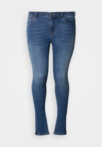 Közép kék farmerból készült skinny jeans, enyhén kopott hatással, közepes derékrésszel és enyhén bolyhos szegéllyel a bokánál.