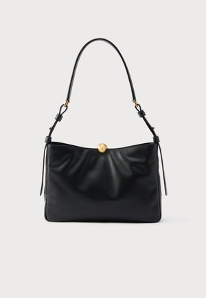 Black leather handbag with a soft, gathered design. Features a rounded gold hardware closure and a single slender shoulder strap.