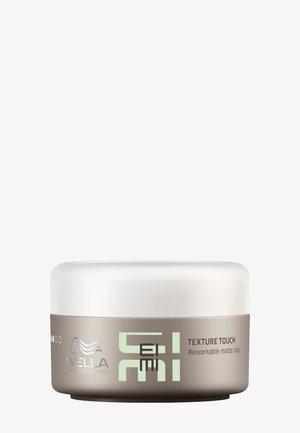 Contenitore di argilla opaca rielaborabile per lo styling dei capelli Wella Professionals EIMI Texture Touch con base taupe e coperchio bianco.