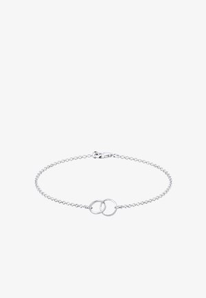 Bracelet délicat en chaîne argent avec deux anneaux entrelacés au centre et fermeture à mousqueton.