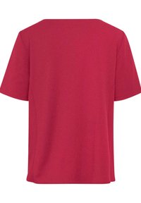 T-shirt rosso a maniche corte realizzato in tessuto morbido. Presenta un colletto rotondo semplice e una vestibilità ampia e rilassata. Texture liscia, senza fantasie.