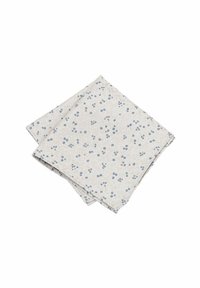 Cotton napkin featuring a light beige background with small blue floral patterns. The fabric has a textured, woven appearance.