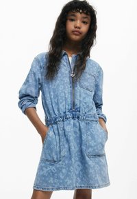 Denimkleit heleda sinise loomaprindiga, ees lukuga, elastse vöökohtaga, pikkade varrukatega ja küljetaskutega. Pehme struktuur ja lõdva disainiga.