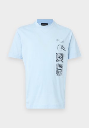 Light blue short-sleeve t-shirt with black graphic stamps, including palm tree, floral design, and text "Italian Summer" on the front right side.