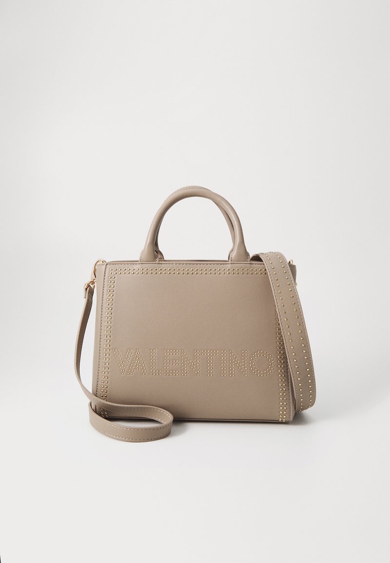 Tan leather handbag with a structured design, featuring the embossed "Valentino" logo and gold stud accents along the edges. Includes a detachable strap.
