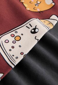 Cotton fabric featuring a maroon section with cartoon animal designs and a cream section with colorful dots, paired with a dark gray texture.