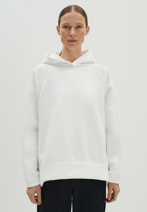 Weißer Kapuzenpullover mit lockerer Passform, Raglanärmeln und strukturierten Material. Verfügt über eine Kängurutasche und gerippte Bündchen.