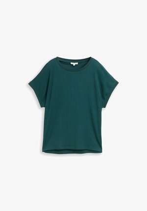 Blouse à manches courtes vert foncé texturée avec encolure ronde et coupe ample, étalée à plat sur un fond blanc.