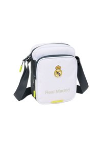 Borsa a tracolla bianca e grigia del Real Madrid con logo e spallaccio regolabile, tasca anteriore con zip e tirazip gialli.