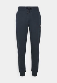 Mörkblå sweatshirtbyxor i mjukt bomullsmix. Har dragsko i midjan, resår i anklarna och en liten logotyp på sidan.