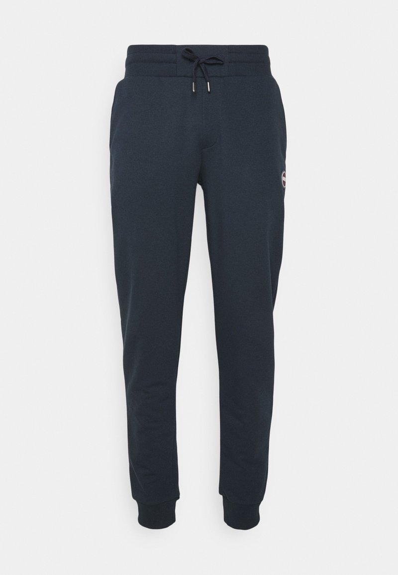 Mörkblå sweatshirtbyxor i mjukt bomullsmix. Har dragsko i midjan, resår i anklarna och en liten logotyp på sidan.