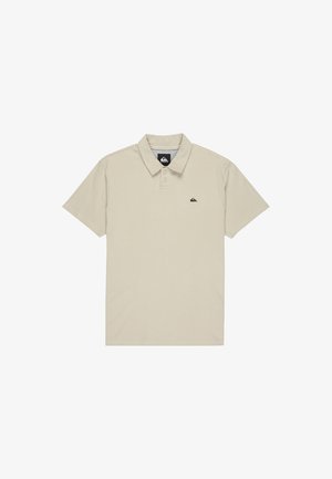 Beige polo shirt made of cotton blend. Features a collared neckline, short sleeves, and a small black logo on the left chest.