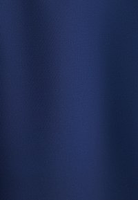 Donkerblauwe textuurstof met een glad oppervlak, dat subtiele kleurvariaties vertoont. Het materiaal lijkt lichtgewicht en duurzaam.