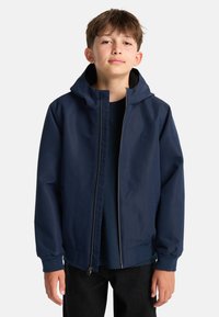 Marineblå hættetrøje med lynlås, der har et ensfarvet design, elastiske ærmer og et diskret logo på brystet. Holdbart, vandafvisende materiale.