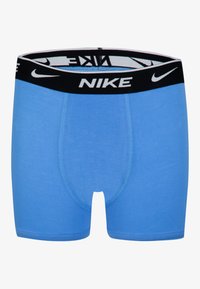 Zili vīriešu boxeri gaiši zilā krāsā, izgatavoti no mīksta materiāla ar melnu elastīgu jostu, uz kuras ir Nike logo baltā krāsā.