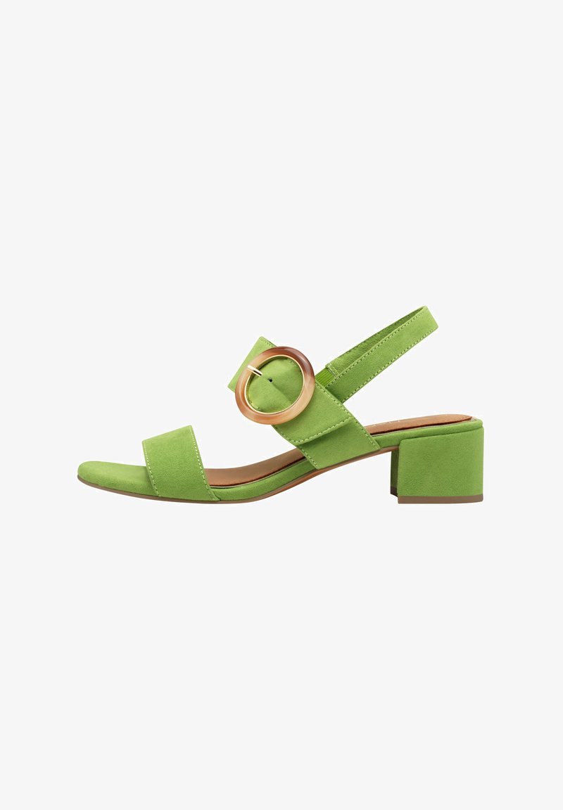 Grønn semsket sandal med blokkhel, med to brede stropper og en sirkulær detalj. Åpen tå-design; justerbar slingback-stropp.